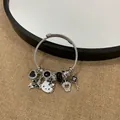 DIY silver braided charm bracelet featuring Hello Kitty and black butterfly pendants - Black Bowtie Cat Style