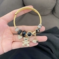 Gold stainless steel twisted wire bracelet featuring black beads and bear charms - Black Zirconia Ring Bear Bracelet