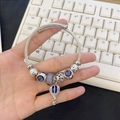 Silver cable charm bracelet featuring purple faceted beads and a blue hot air balloon charm - Blue Balloon Bracelet