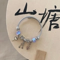 DIY beaded charm bracelet with heart, music note charms and iridescent aurora beads - Dreamy Starry Blue Bracelet