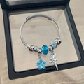 Silver beaded bracelet featuring dark blue crystal and winged fairy pendant in a box - Blue Flower Fairy Bracelet