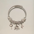 Silver cable chain bracelet featuring assorted charms like hearts, clover, and love pendant - Silver Zirconia Heart Elephant Bracelet