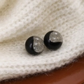Elegant black round stud earrings with shimmering silver glitter on white knit background - Black Starry Round Style (E6091-19)