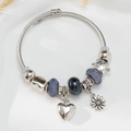 Elegantes silbernes Charm-Armband mit Herz- und Gänseblümchen-Anhängern und Perlen - Gänseblümchen
