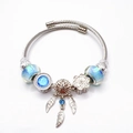 Zilveren bedelarmband met blauwe glaskralen en levensboom blad hanger sieraad - Blauwe Droombloem