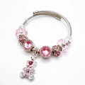 Elegante zilveren kabelarmband met roze kristallen en een schattige teddybeerhanger - Roze beer
