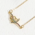 Golden MOM necklace with colorful zircon heart pendant on white textured surface - Multicolor Zirconia MOM Style