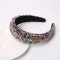 Macro detail of hand-sewn multicolor crystal beads on a wide velvet padded headband - Colorful