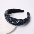 Detail of padded headband featuring multi-faceted dark blue crystals on a ceramic plate - Navy Blue