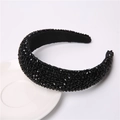 Close-up of black beaded wide headband placed on a white ceramic dish for detail - Black