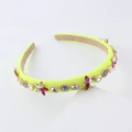 Neon yellow headband with colorful rhinestones and velvet lining on a geometric stand - Yellow