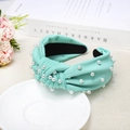 Detailed view of mint green knotted headband with faux pearls and textured woven fabric - Mint Green