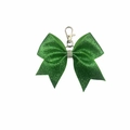 Close-up of sparkling green leather bow keychain with crystal inlay and silver metal clasp - Green