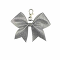 Close-up of sparkling silver sequin bow keychain with rhinestones and metal clasp - Silver
