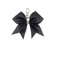 Macro shot of black glitter bow keychain with rhinestones and silver metal clasp - Black