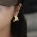 Elegant textured golden triangle stud earring shown on model with minimalist geometric style - Gold