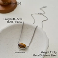 Detail showing a geometric tiger eye stone pendant on a fine stainless steel chain - Silver Pebble Tiger Eye (NMSN-M412-2)
