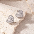Elegant heart-shaped stud earrings featuring sparkling cubic zirconia stones in silver finish - Hollow Heart Zirconia