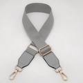 Detail view of light grey adjustable canvas strap with gold lobster clasps and metal buckle - Light Gray / Silver