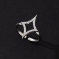 Close-up of minimalist four-pointed star ring with clear cubic zirconia pavé - Minimalist Fashion Ring (R)