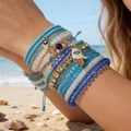 Böhmisches mehrlagiges Set aus Perlenarmbändern mit bösem Blick und Hamsa-Hand - Blau Gold 11-teiliges Set