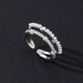 Detail view of a double-layered silver ring with white pearls and sparkling cubic zirconia - Flower Open (Style 7)