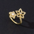 Macro detail of gold plated open ring featuring double floral design with pearls and zircons - Simple Pearl (Style 8)
