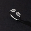 Close-up of adjustable silver ring featuring two heart shapes pave-set with white zircons - Elegant Pearl (Style 13)