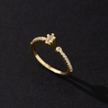 Macro shot of gold-plated open ring featuring sparkling cubic zirconia and pearl details - Vintage Style (Style 16)