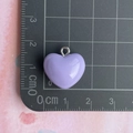 Close-up of purple resin heart charm with silver metal ring on a measurement scale - Purple Heart Pendant