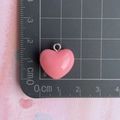 Detail shot of a 1.5cm pink resin heart pendant with silver loop on a scale ruler - Watermelon Red Heart Pendant