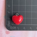 Macro view of 1.5cm red resin heart pendant with silver ring on measurement grid - Large Red Heart Pendant