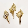 Macro shot of natural spiral shells with gold plated edges for DIY jewelry making - Murex Conch
