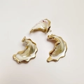 Detailed view of three natural shell charms with polished gold electroplated edges for DIY jewelry - Butterfly Wing Conch