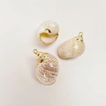 Detailed macro view of natural cowrie shell pendants with elegant golden electroplated edges - Frosting Cocoa Conch