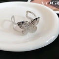 Close-up of a silver butterfly open cuff bracelet with detailed metal engravings - Hollow Butterfly (22# Eco-Silver)