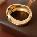Detailed view of wide gold metal hinged bracelet on leather jewelry box - Thickened Polished (12# Gold)