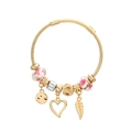 Golden twisted cable bracelet with pink floral beads, heart and feather charms on white background - Pink