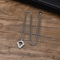 Detailed close-up of a men's geometric titanium steel pendant with a square box chain - Inverted Triangle - Steel Color