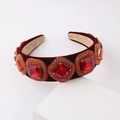 Macro detail of red velvet headband with square faceted gems and crystal embellishments - Red