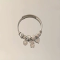 Detail of adjustable silver bangle featuring bear and heart charms with crystal beads - White - Bear