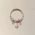 Macro view of stainless steel charm bracelet featuring pink beads and butterfly pendants - Pink - Butterfly