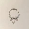 Detailed macro of silver double-wrap charm bracelet with blue beads and crystal butterflies - White - Butterfly