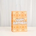 Detail of orange kraft paper gift bag with beige paw prints and Happy Birthday text - Orange Polka Dot Paw Style (545-6)