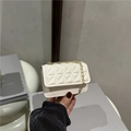 Mini sac bandoulière blanc matelassé avec chaîne dorée tenu à la main - Blanc