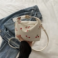 White corduroy handbag featuring cute red cherry embroidery and golden metal hardware - White