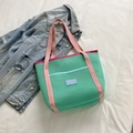 Mint green mesh children's tote bag with pink handles and a blue front pocket detail - Green