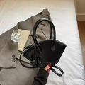 Chic black fan-shaped handbag in premium vegan leather with elegant knot tassel accents - Black