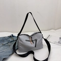 Grey nylon messenger bag with wide black strap and orange zipper detail in casual setting - Gray