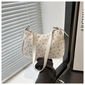 Detail shot of the white floral underarm bag with red cherry print and fine texture leather - Cherry